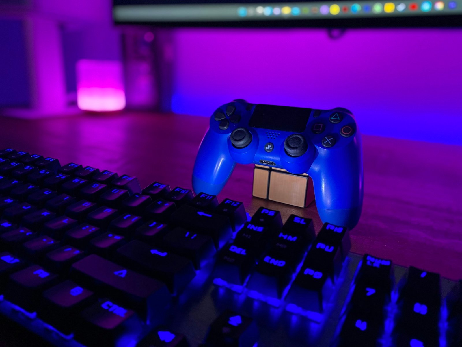 Game controller illuminated in purple and blue